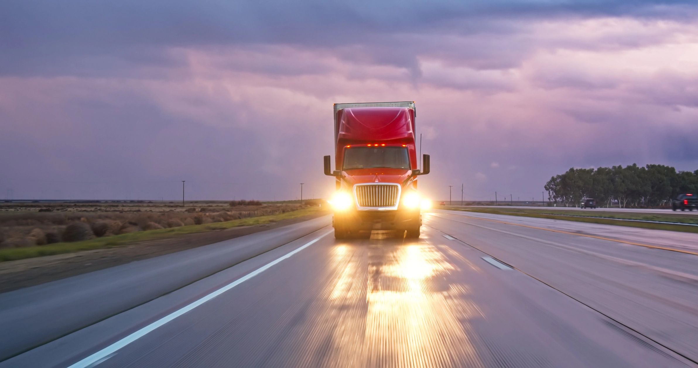 Truck driving at sunset