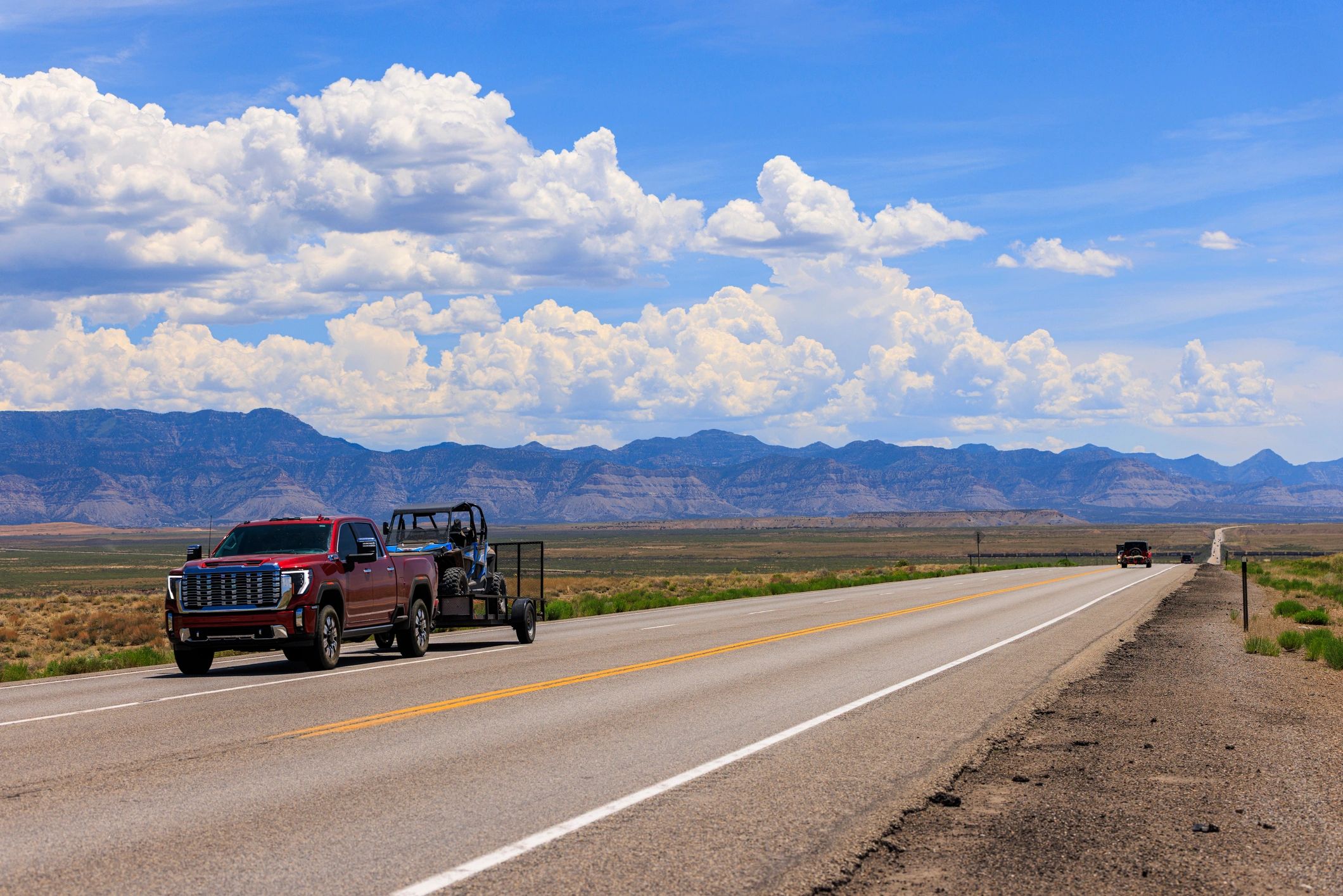 Pickup truck towing an off-road utility vehicle